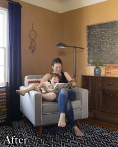 Woman and child in a grey chair with an orange wall