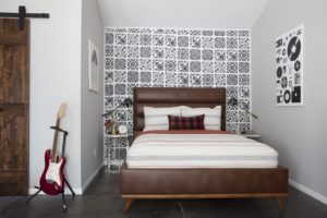 brown bedframe with tiled wall behind