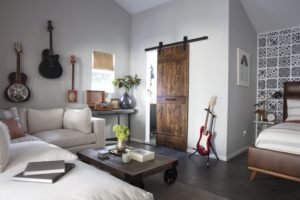 white sectional with guitars on wall different angle