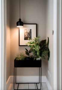 Black console table with plants and a hanging light at the end of a hallway