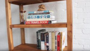 bookcase with books and hour glass