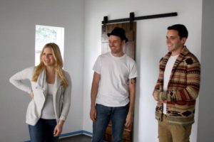 two males and female looking at something unseen