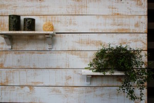 This accent wall is created using rustic shelves