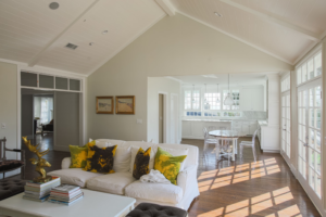 Tie dye throw pillows add a nice pop of color to this neutral room