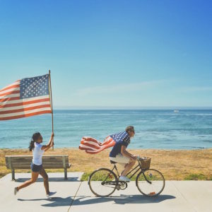 A couple celebrate the 4th of July with their flags