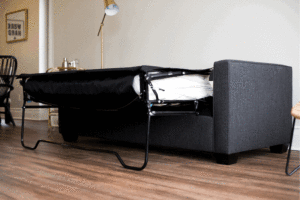 grey sleeper sofa on wood floor