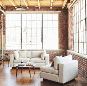two piece white sectional next to armless chair on the right