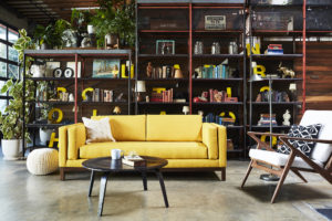 yellow sofa on left with white accent chair on right