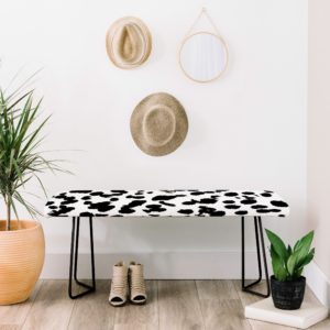spotted white and black bench with potted plants