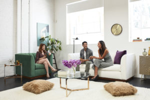 white sofa on right and green chair on left in living room