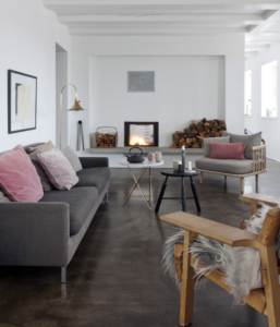 pink sofa and grey chair next to grey coffee table in living room