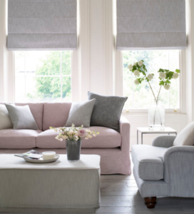 modern living room with grey sofa on left and two accent chairs on right
