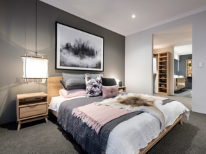 Contemporary bedroom with large bed and wood nightstand on right