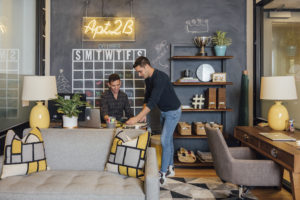 decorated office with painting in between chair on left and desk on right