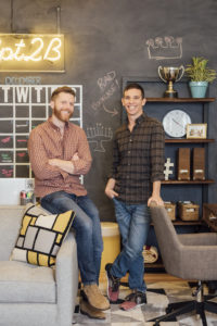two men in office smiling