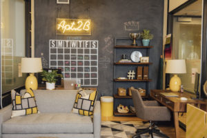 neon sign on chalkboard with grey chair