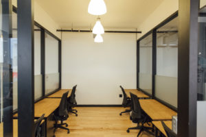 office with desks on the right and left with office chairs