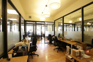 office with desks on the right and left with office chairs