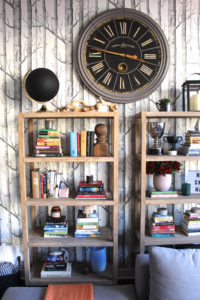 blue sofa on left with square wood coffee table